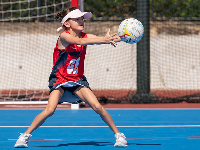 HKCC netball junior player catches the ball